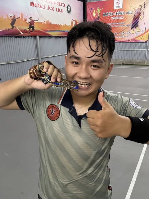 A finisher holding their X Challenge medal